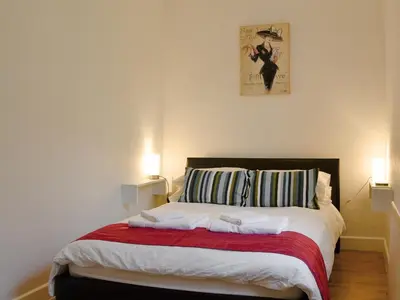 a bedroom with a large bed with two lamps at Katellen Cottage in Threlkeld