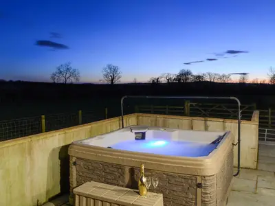 a jacuzzi tub sitting on a patio at Little Meadow in Dearham