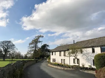 a road leading to a white house at Melbreak in Lorton