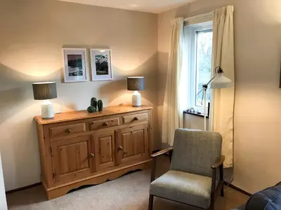 a room with a dresser and a chair and a window at Melbreak in Lorton