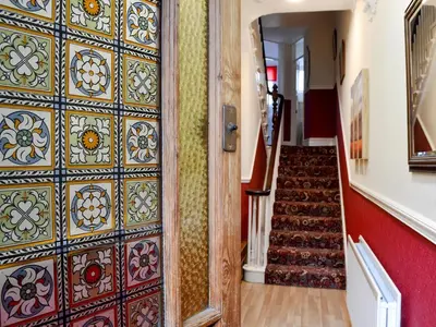 a hallway with a door with colorful tiles at Bianca Rose in Keswick