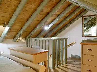 a attic bedroom with a bed and a desk at Harrison's Lodge - Uk1259 in Threlkeld