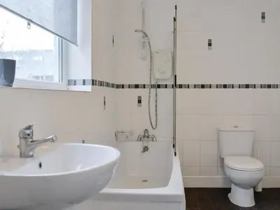 a bathroom with a sink and a shower and a toilet at Gilbert's Warrant in Keswick