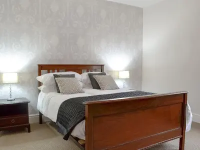 a bedroom with a bed with white sheets and pillows at Gilbert's Warrant in Keswick