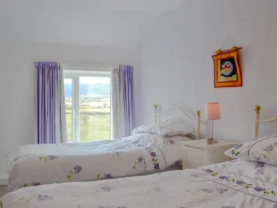 two beds in a bedroom with a window at The Tottsie in Bassenthwaite