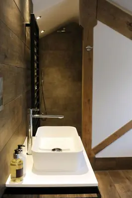 a bathroom with a white sink in a room at 1692 Wasdale in Gosforth
