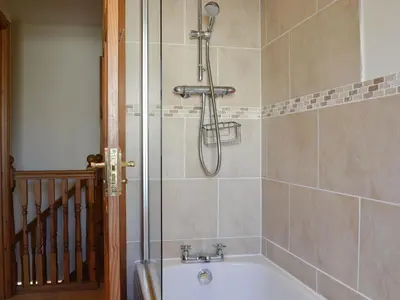 a shower in a bathroom with a bath tub at The Costins in Allonby