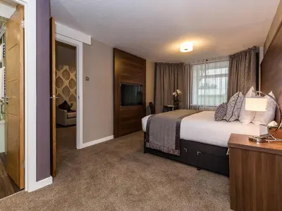 a hotel room with a bed and a television at The Melbreak Hotel in Great Clifton