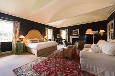 a bedroom with a bed and a couch at Cavens Country House, DINNER INCLUSIVE! in Kirkbean