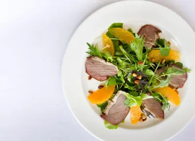 a plate of food with oranges and greens at Cavens Country House, DINNER INCLUSIVE! in Kirkbean