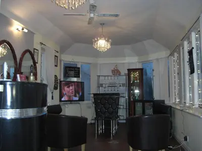 a bar with black chairs and a chandelier at Lynebank House Hotel, Bed & Breakfast in Carlisle