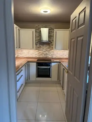 a kitchen with white cabinets and a stove top oven at Retreat at The Knowe Auchincruive Estate in Ayr