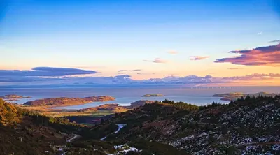 a view of a large body of water at sunset at Little Dunbar Cottage in Kirkbean
