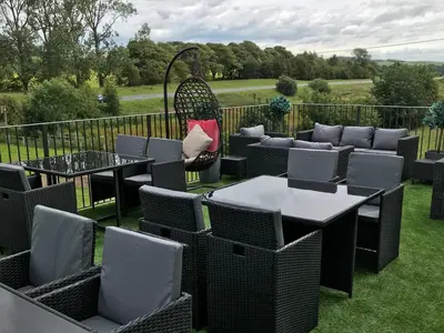 a patio with tables and chairs on the grass at Sure Hotel by Best Western Lockerbie in Lockerbie
