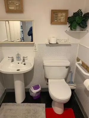 a bathroom with a white toilet and a sink at The Thistle in Stranraer