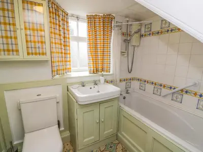 a bathroom with a sink and a tub and a toilet at 27-29 St Marys Place in Kirkcudbright