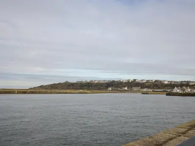 a large body of water with a city in the background at Harbour Side in Maryport