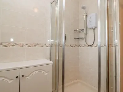 a bathroom with a shower and a sink at Harbour Side in Maryport