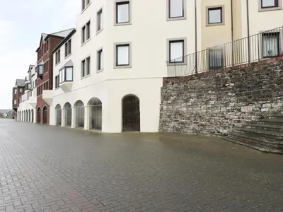 an empty street in front of a building at Harbour Side in Maryport