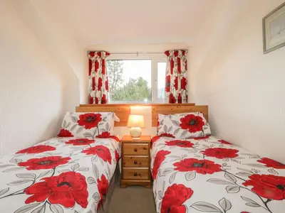 a bedroom with two beds and a window at Derwent Edge in Portinscale