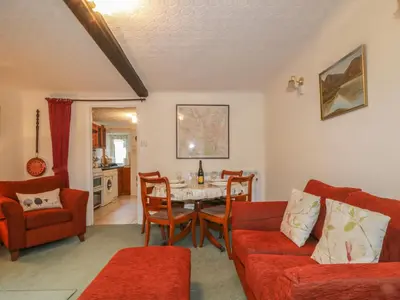 a living room with a table and chairs at Derwent Edge in Portinscale