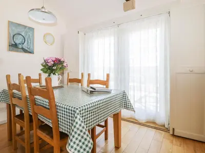 a dining room table with a green and white checkered table cloth at Skiddaw in Cockermouth