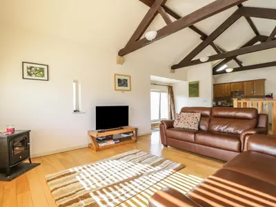 a living room with a couch and a tv at Skiddaw in Cockermouth
