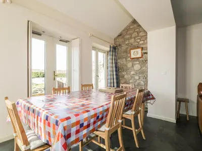 a dining room with a table and chairs at Beckside in Cockermouth