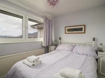 a bedroom with a bed with towels on it at Manesty View in Keswick