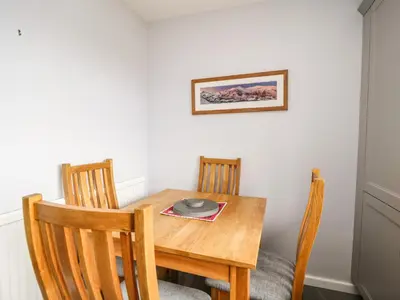 a dining room table with two chairs and a plate on it at Manesty View in Keswick