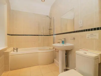 a bathroom with a sink and a tub and a toilet at The Old Vicarage in Thirlmere