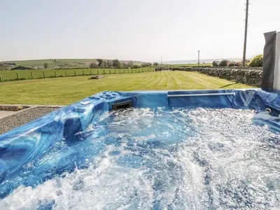 a blue water slide with a field in the background at Longforth Farm Cottage in Gillespie