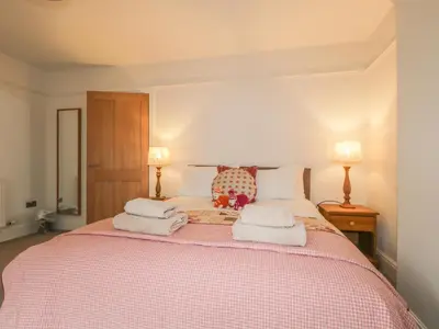 a bedroom with a bed with towels on it at Roselea in Keswick