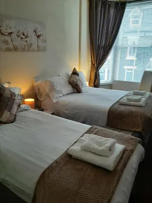 a hotel room with two beds with towels on them at Lyndhurst in Keswick