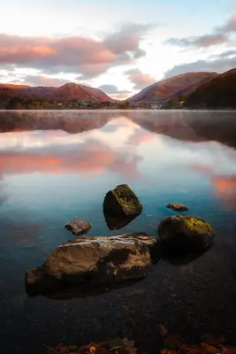 a large rock in the middle of a lake at Moss Grove Organic in Grasmere