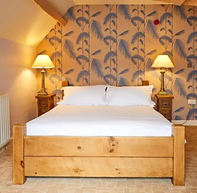a bedroom with a bed and two lamps at Moss Grove Organic in Grasmere