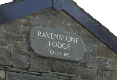a sign on the side of a stone building at Ravenstone Lodge Country House Hotel in Keswick