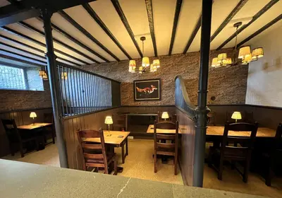 a dining room with a table and chairs at Ravenstone Lodge Country House Hotel in Keswick