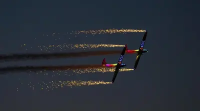 two planes are flying in the sky at night at No27 Ayr Beach - Coorie Doon Stays in Ayr
