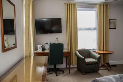 a hotel room with a desk and a chair at Keld Green House in Seascale