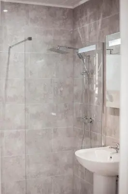 a bathroom with a shower and a sink at Keld Green House in Seascale