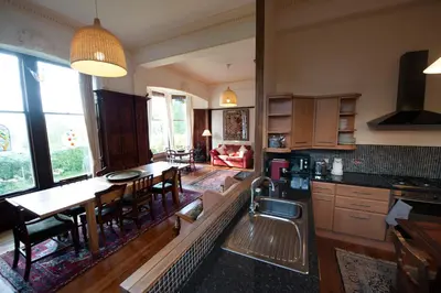 a kitchen and living room with a couch and a table at Warriston Apartment at Holm Park in Moffat
