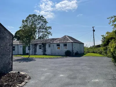 an old white house with a driveway at Barcloy Honey House in Kirkcudbright