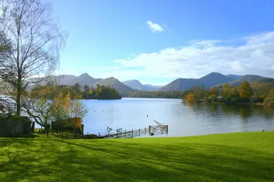 a view of a lake with a dock and mountains at The Borrowdale Hotel in Keswick