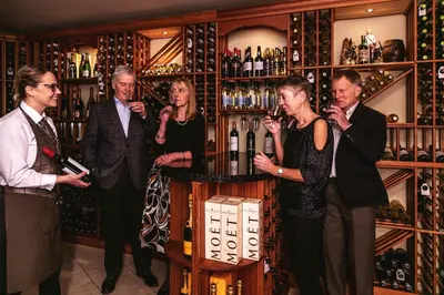 a group of people drinking wine in a wine cellar at The Borrowdale Hotel in Keswick
