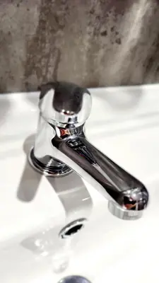 a chrome sink faucet on a white sink at The Market Inn Hotel in Castle Douglas