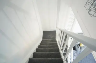 a staircase in a room with white walls at The Annex in Carlisle