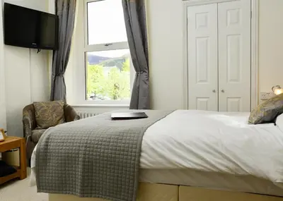 a bedroom with a bed and a window at West View in Keswick