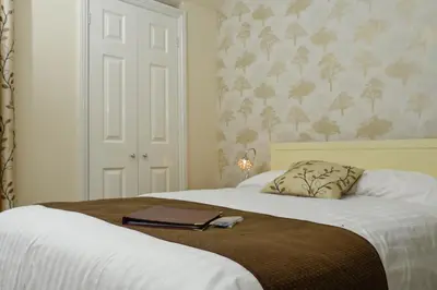 a bedroom with a bed with a book on it at West View in Keswick