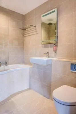 a bathroom with a toilet and a sink and a tub at The Grand at Grasmere in Grasmere